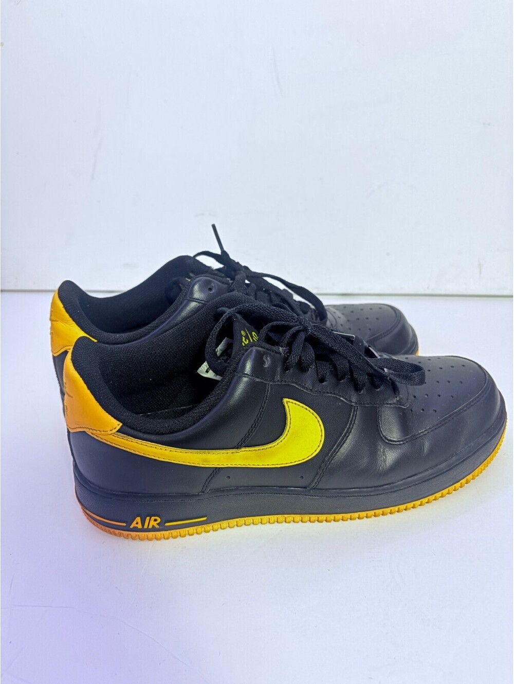 Nike Air Force 1 black and yellow low top sneakers